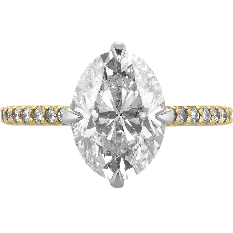 Image of oval diamond engagement ring with compass prongs and pave band in yellow gold | Buchroeders Jewelers